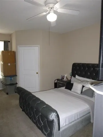 a bedroom with bed and window