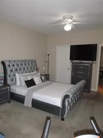 a bedroom with two beds and a flat screen tv