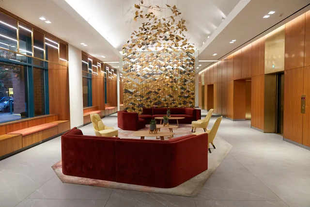 a view of a hallway with closet and a bathroom