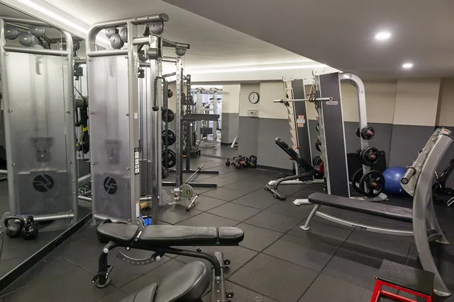 a living room with furniture and large windows