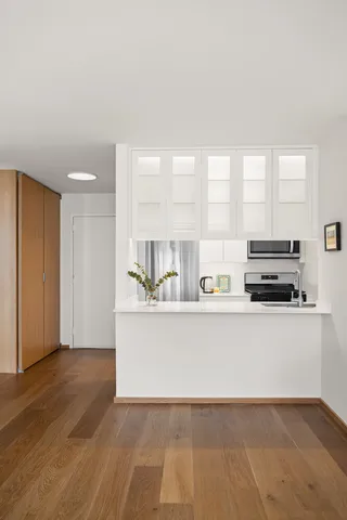 a bedroom with a bed and a large mirror