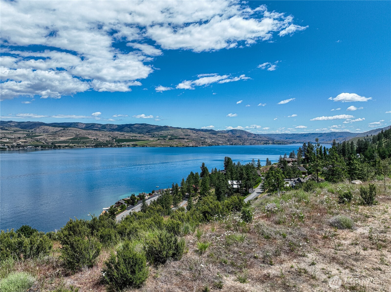 4620 South Lakeshore Road Chelan, WA 98816 - Photo 11 of 40 a view of a lake with a building in the background