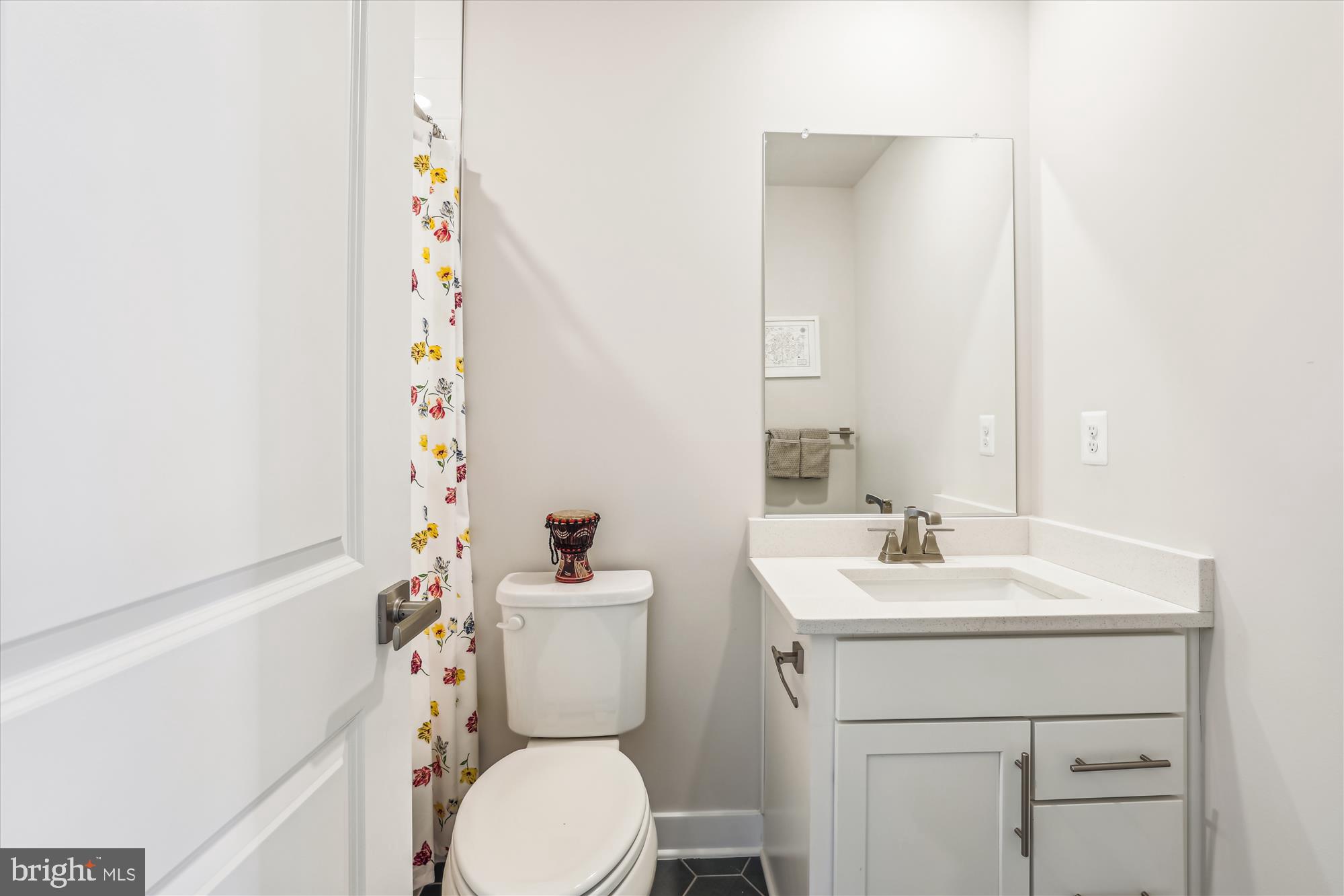 6832 General Davis Drive Northwest Washington, DC 20012 - Photo 22 of 31 a bathroom with a sink a toilet and a mirror