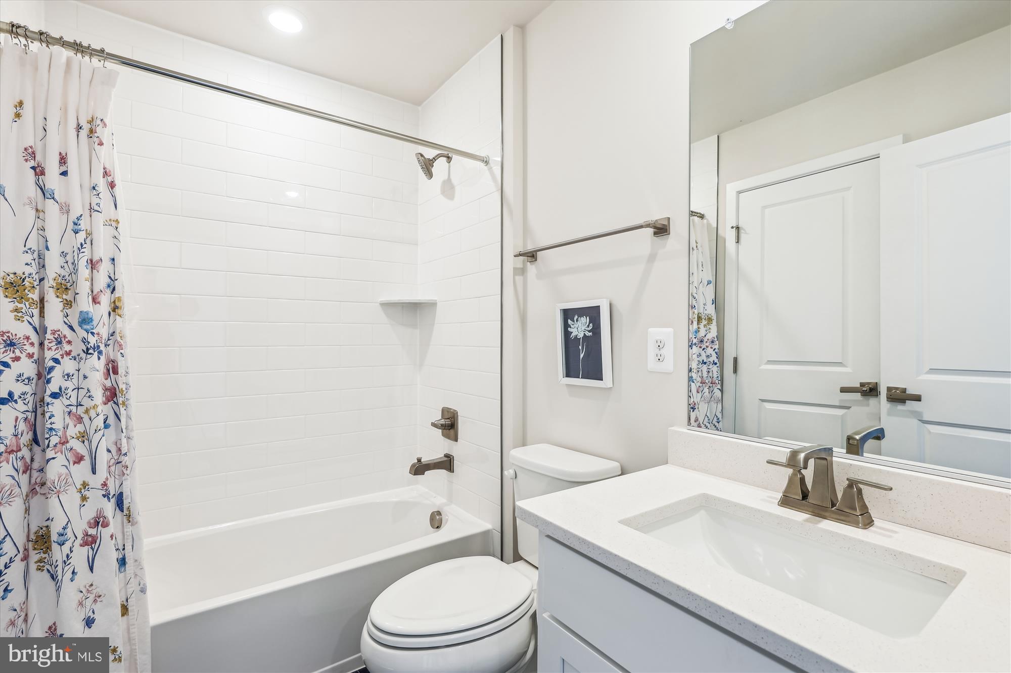 6832 General Davis Drive Northwest Washington, DC 20012 - Photo 23 of 31 a bathroom with a sink a toilet a mirror a bathtub and shower