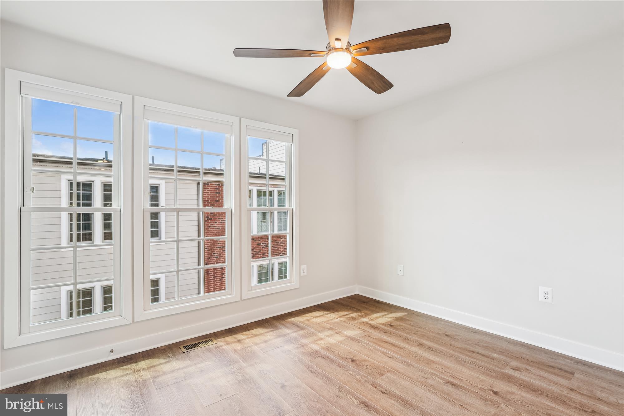 6832 General Davis Drive Northwest Washington, DC 20012 - Photo 25 of 31 an empty room with wooden floor fan and windows