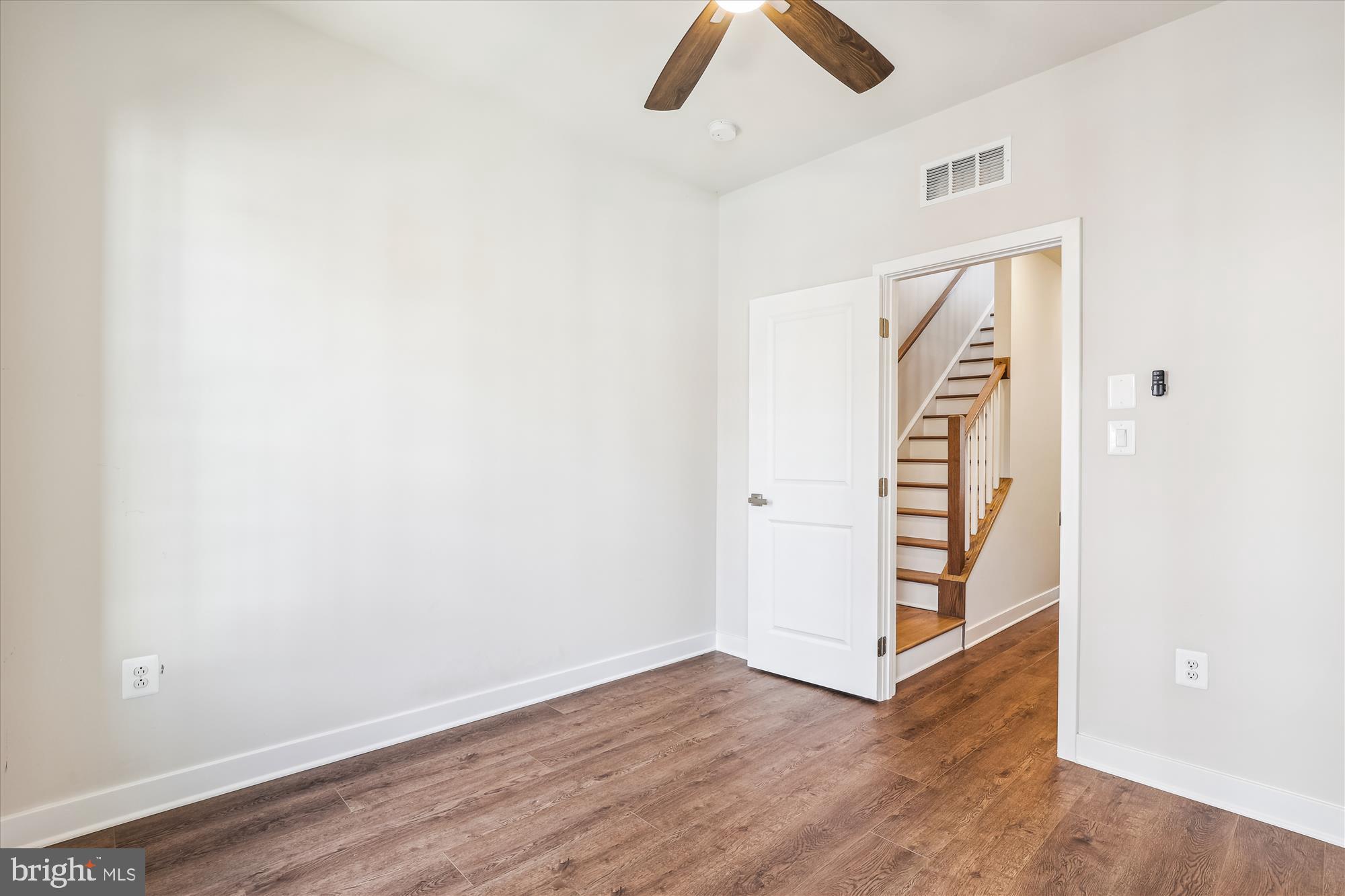 6832 General Davis Drive Northwest Washington, DC 20012 - Photo 27 of 31 an empty room with wooden floor closet and windows