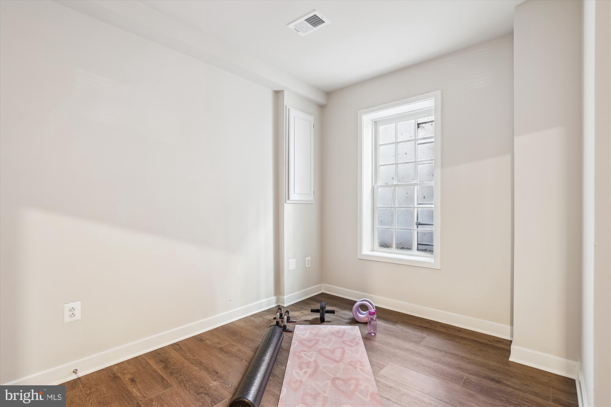 6832 General Davis Drive Northwest Washington, DC 20012 - Photo 30 of 31 an empty room with wooden floor and windows