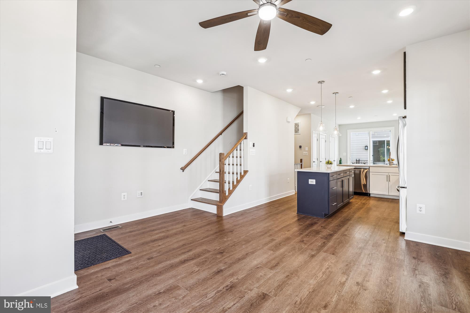 6832 General Davis Drive Northwest Washington, DC 20012 - Photo 4 of 31 a view of an empty room with wooden floor and a ceiling fan