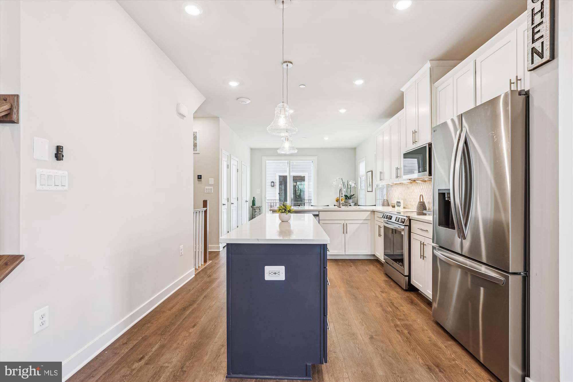 6832 General Davis Drive Northwest Washington, DC 20012 - Photo 5 of 31 a kitchen with kitchen island white cabinets and stainless steel appliances