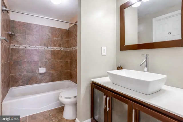 a bathroom with a sink a toilet and a bathtub