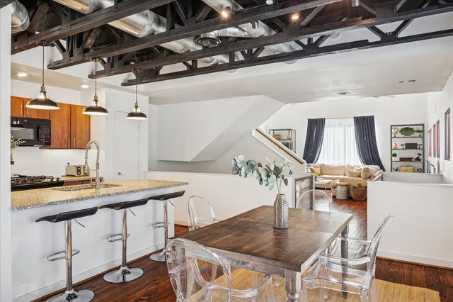 a kitchen with a table chairs and a stove