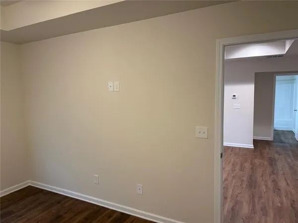 a view of a room with wooden floor