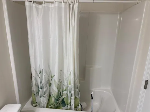 a bathroom with a shower curtain and toilet