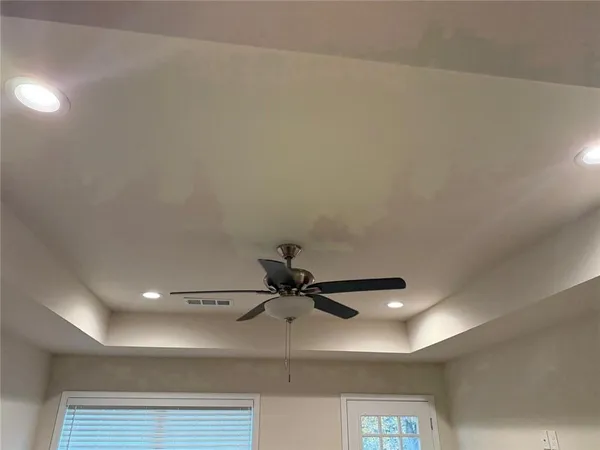 a view of a room with a ceiling fan