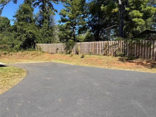a fire hydrant sitting in the middle of a yard