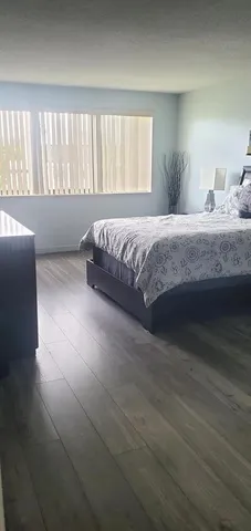 a spacious bedroom with a bed and a window