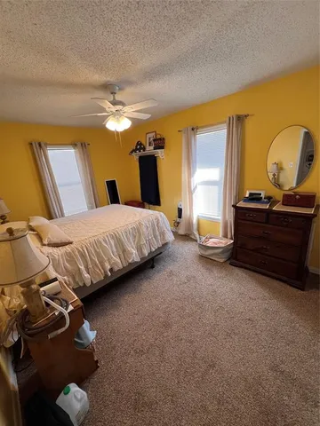 a bedroom with bed and window