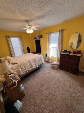 a bedroom with a bed and a mirror