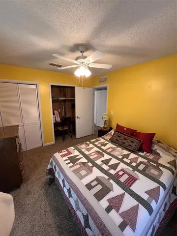 a kitchen with stainless steel appliances a refrigerator a stove a sink dishwasher and white cabinets with wooden floor