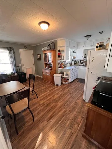 a room with wooden floor and furniture