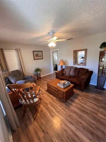a living room with lots of furniture and a wooden floor
