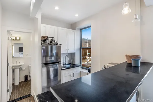 a kitchen with stainless steel appliances a refrigerator and a counter top space