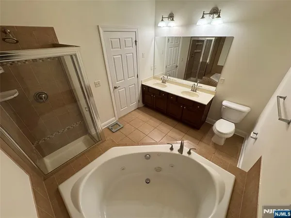 a bathroom with a tub sink and mirror