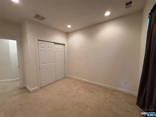 an empty room with closet area