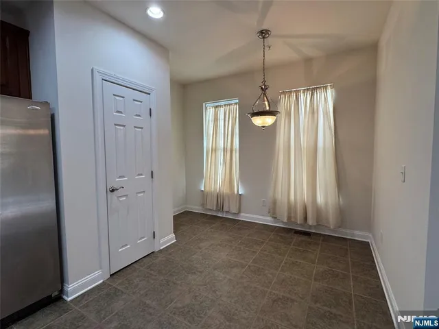 a view of a chandelier fan and refrigerator in a kitchen