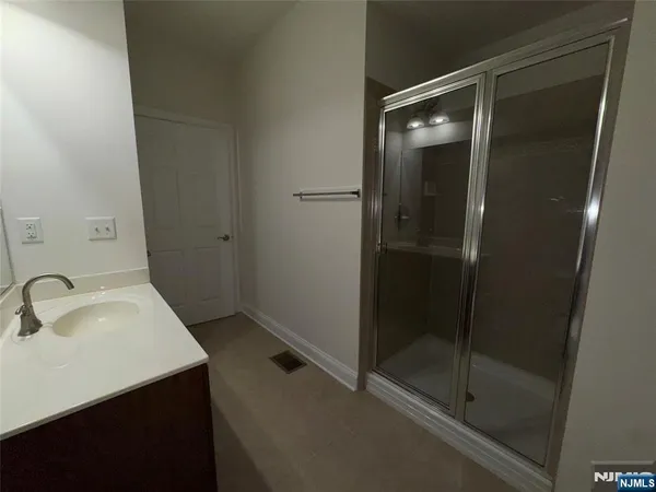 a bathroom with a sink and shower