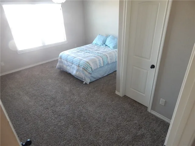 a room with a bed and a window