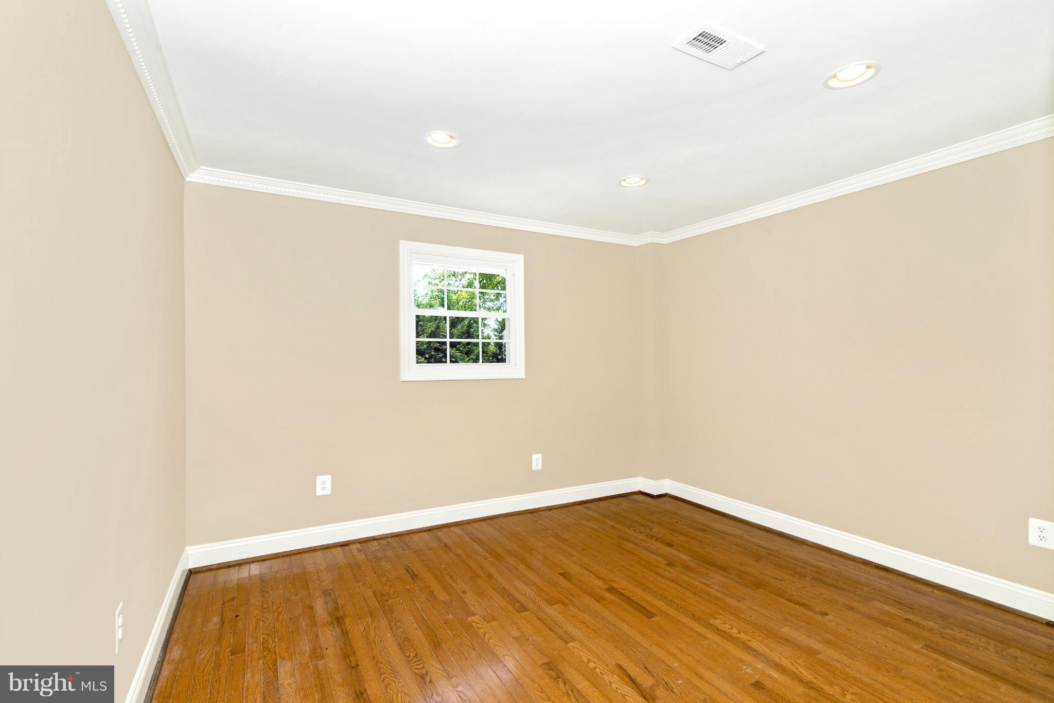18126 Beallsville Road Poolesville, MD 20837 - Photo 11 of 21 an empty room with wooden floor and windows