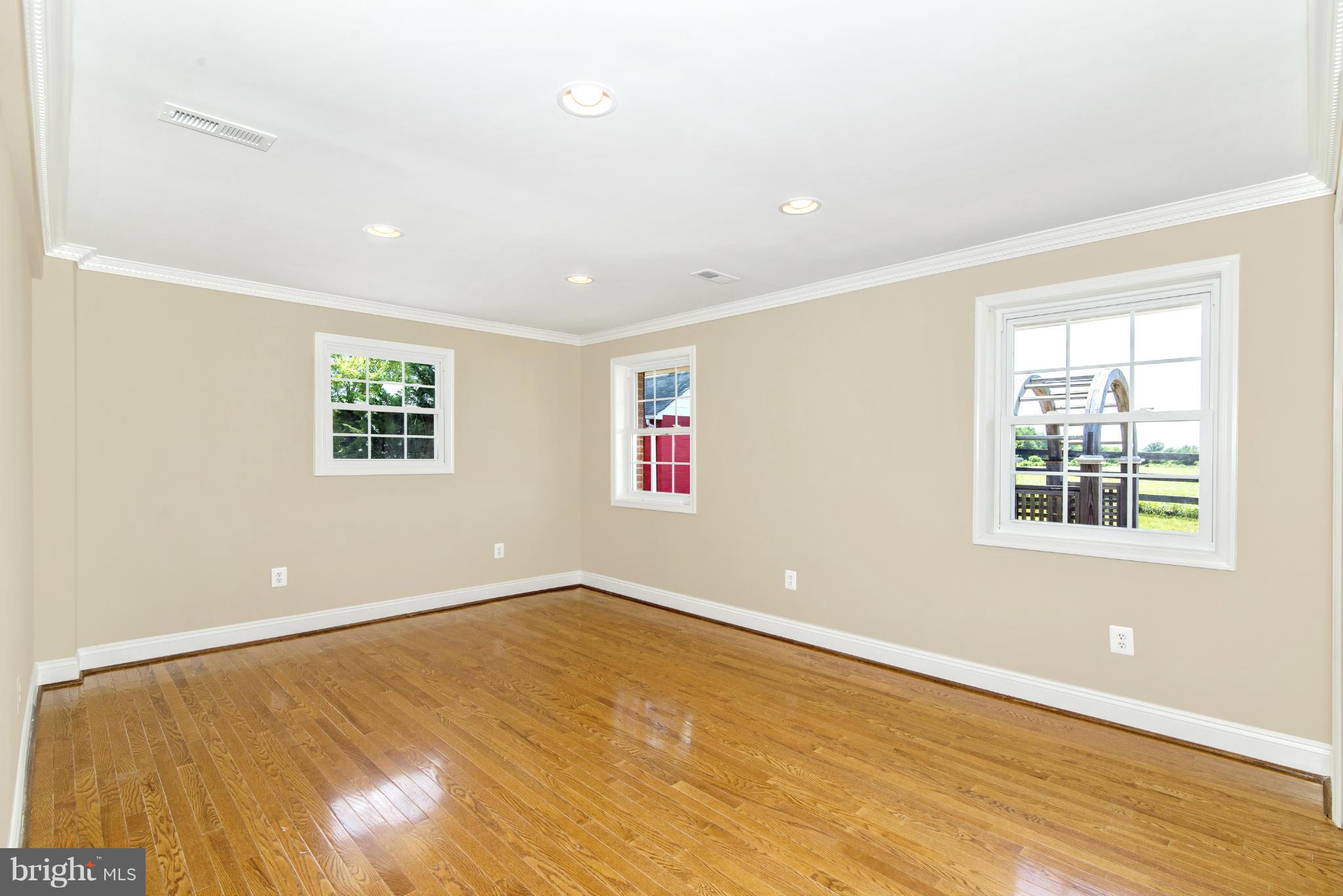 18126 Beallsville Road Poolesville, MD 20837 - Photo 12 of 21 a view of an empty room with wooden floor and a window