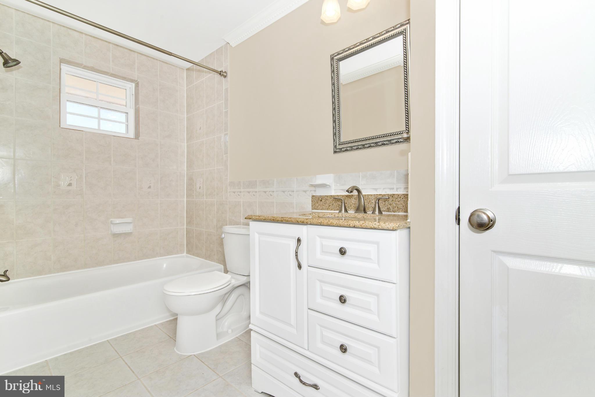 18126 Beallsville Road Poolesville, MD 20837 - Photo 13 of 21 a bathroom with a sink a toilet and bathtub