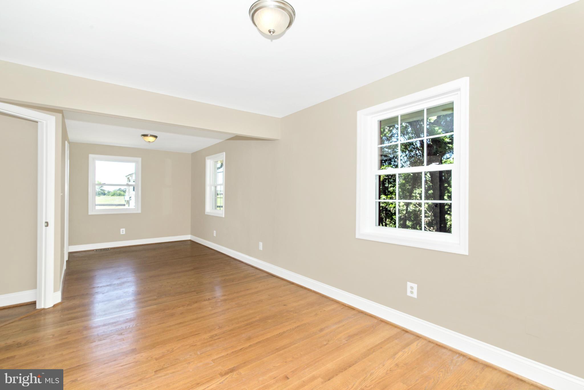 18126 Beallsville Road Poolesville, MD 20837 - Photo 15 of 21 an empty room with wooden floor and windows