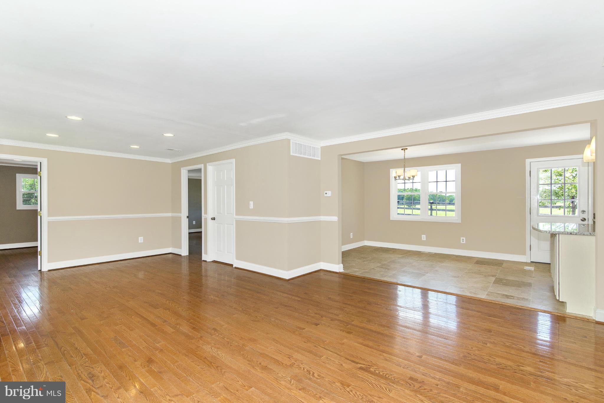 18126 Beallsville Road Poolesville, MD 20837 - Photo 7 of 21 an empty room with wooden floor and windows