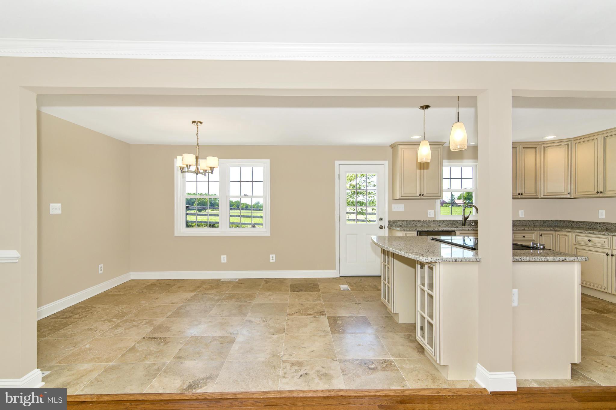 18126 Beallsville Road Poolesville, MD 20837 - Photo 8 of 21 a large white kitchen with kitchen island granite countertop a large window