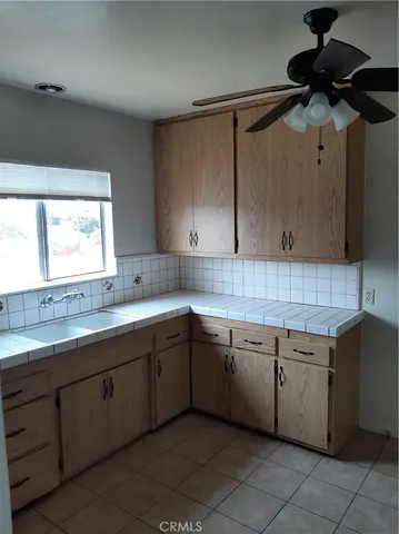 a kitchen with a sink window and cabinets