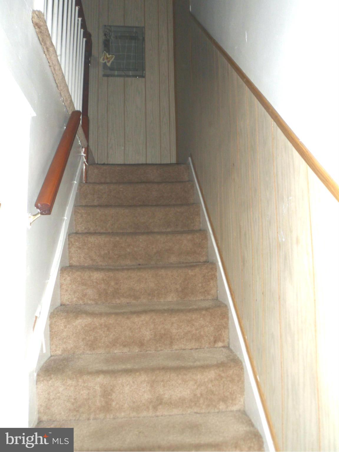 1333 Stonewood Road Baltimore, MD 21239 - Photo 19 of 30 a view of staircase with white walls and windows