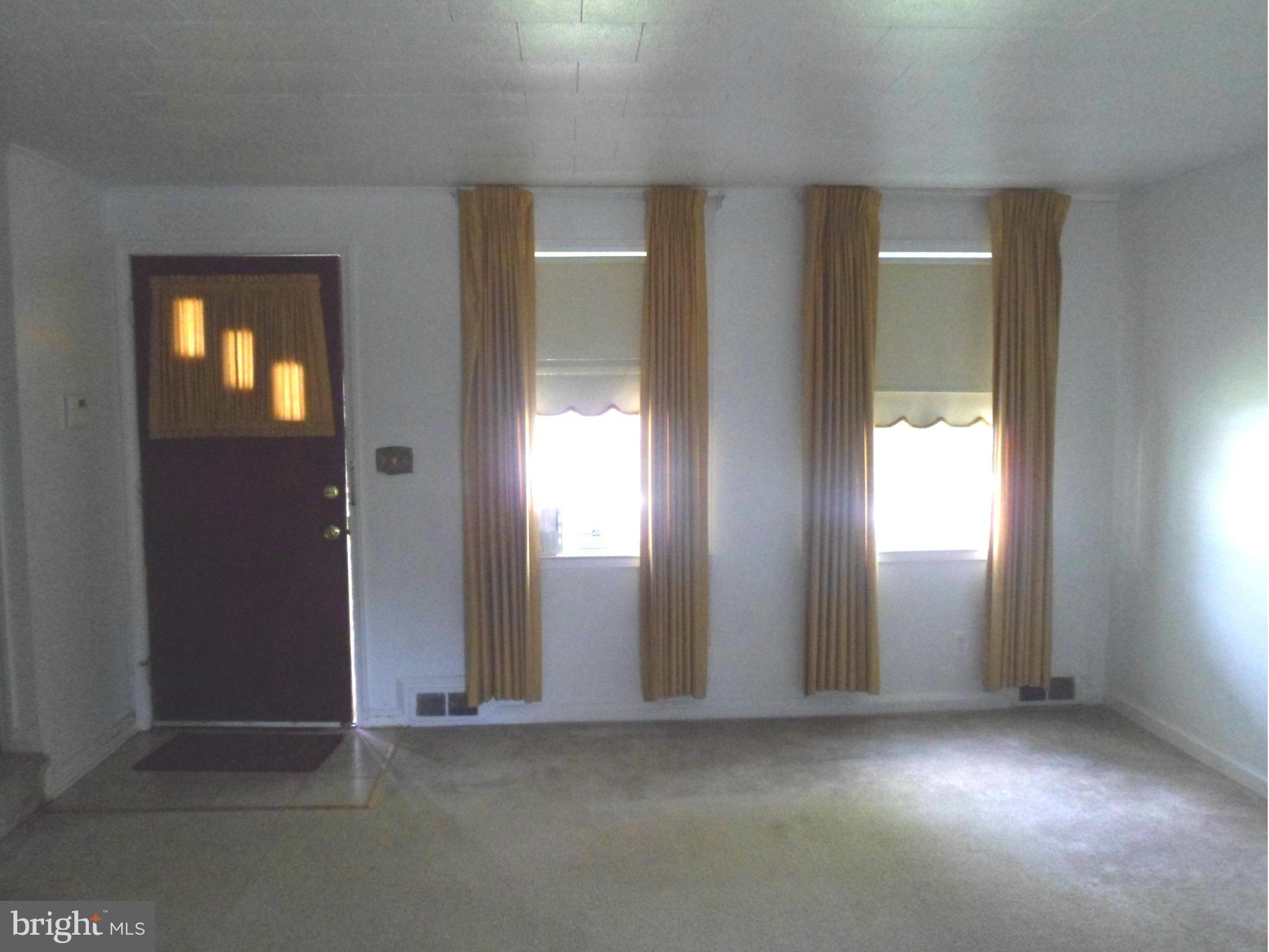 1333 Stonewood Road Baltimore, MD 21239 - Photo 3 of 30 an empty room that has a window