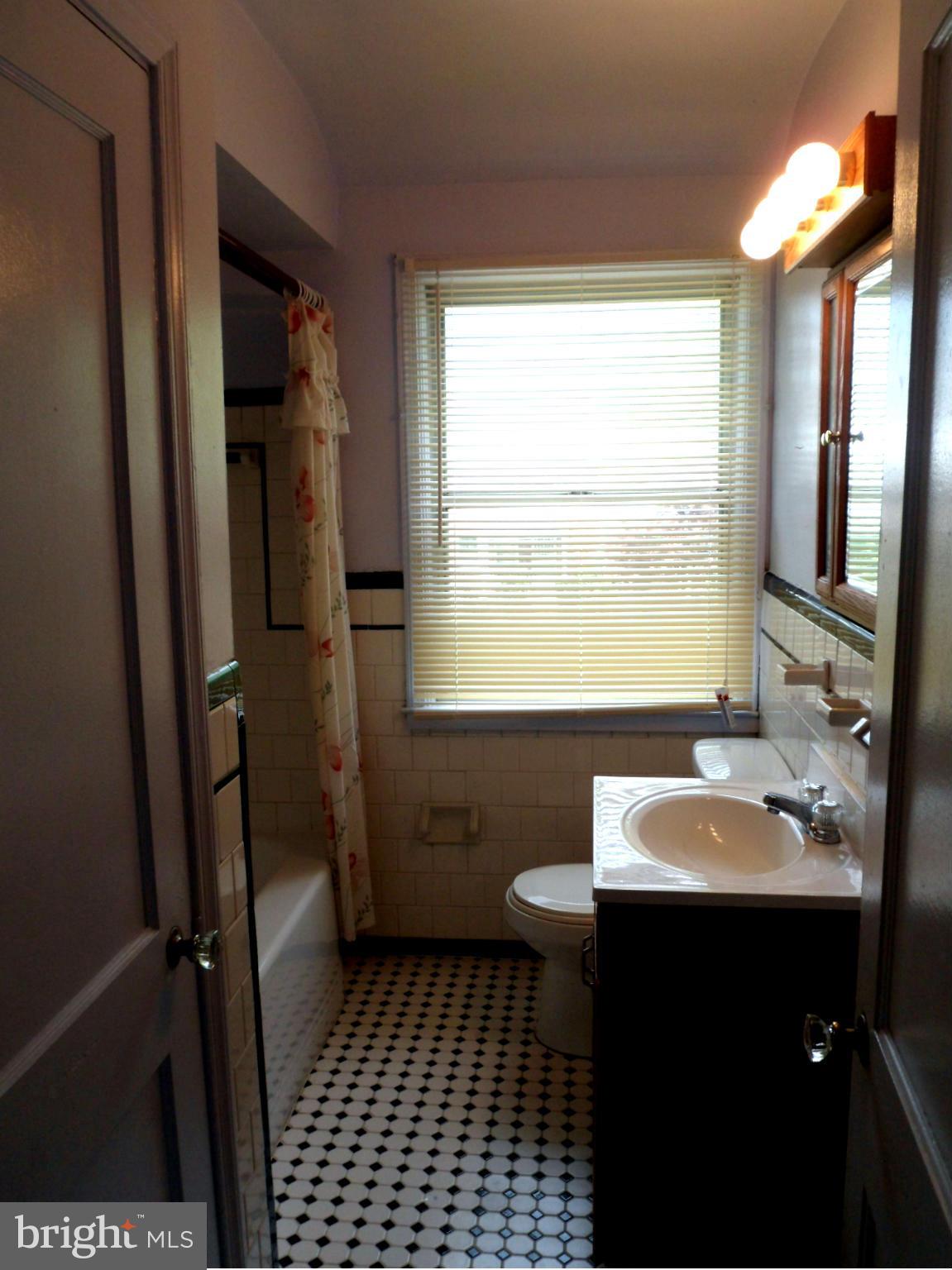 1333 Stonewood Road Baltimore, MD 21239 - Photo 22 of 30 a bathroom with a sink a toilet and shower