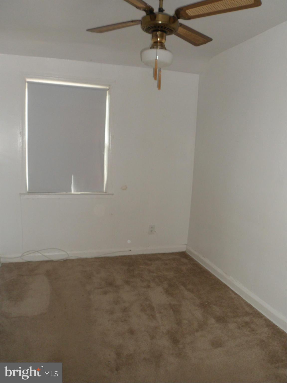 1333 Stonewood Road Baltimore, MD 21239 - Photo 26 of 30 an empty room with a window and a fan