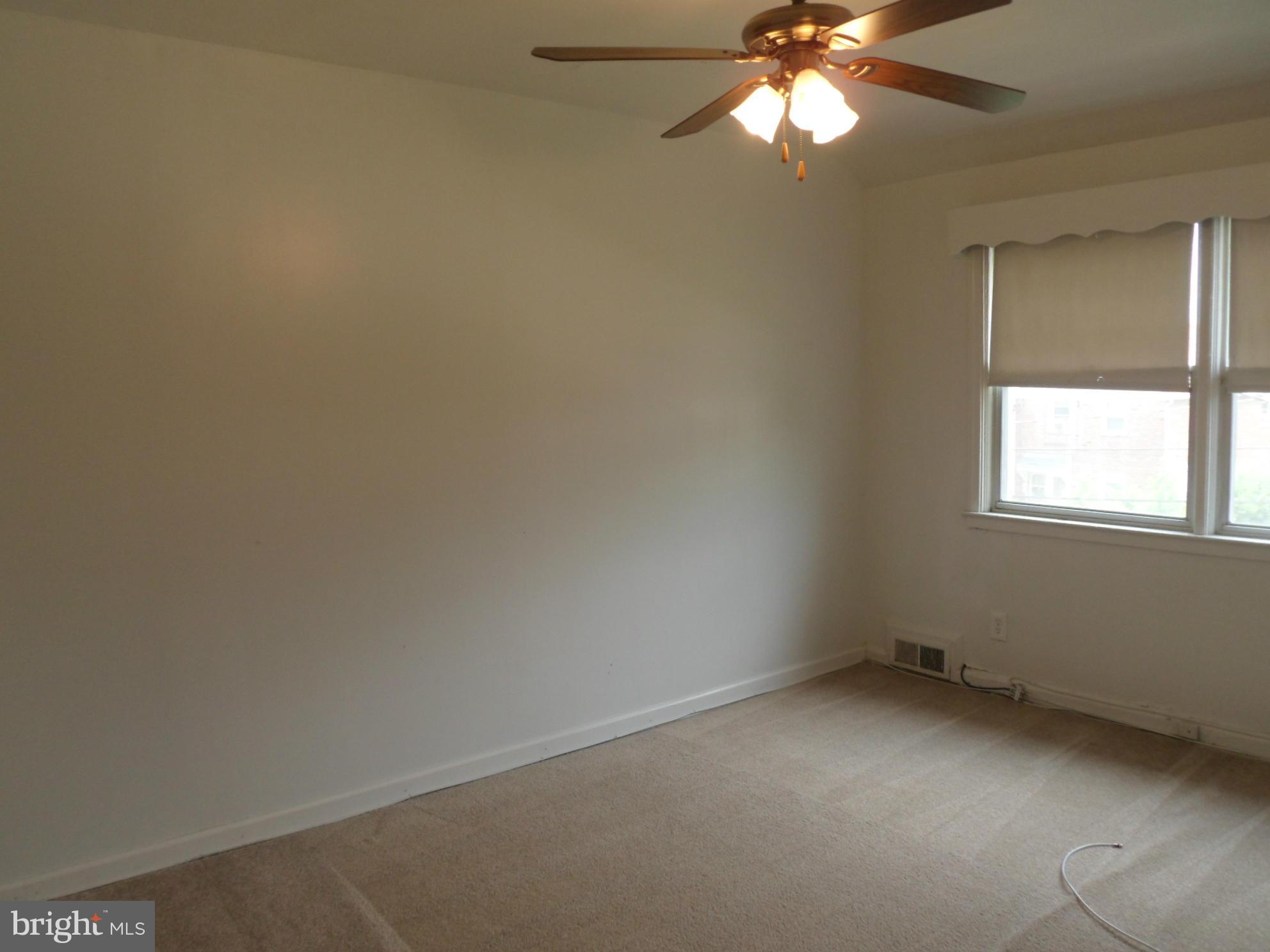 1333 Stonewood Road Baltimore, MD 21239 - Photo 27 of 30 an empty room with a window and a fan