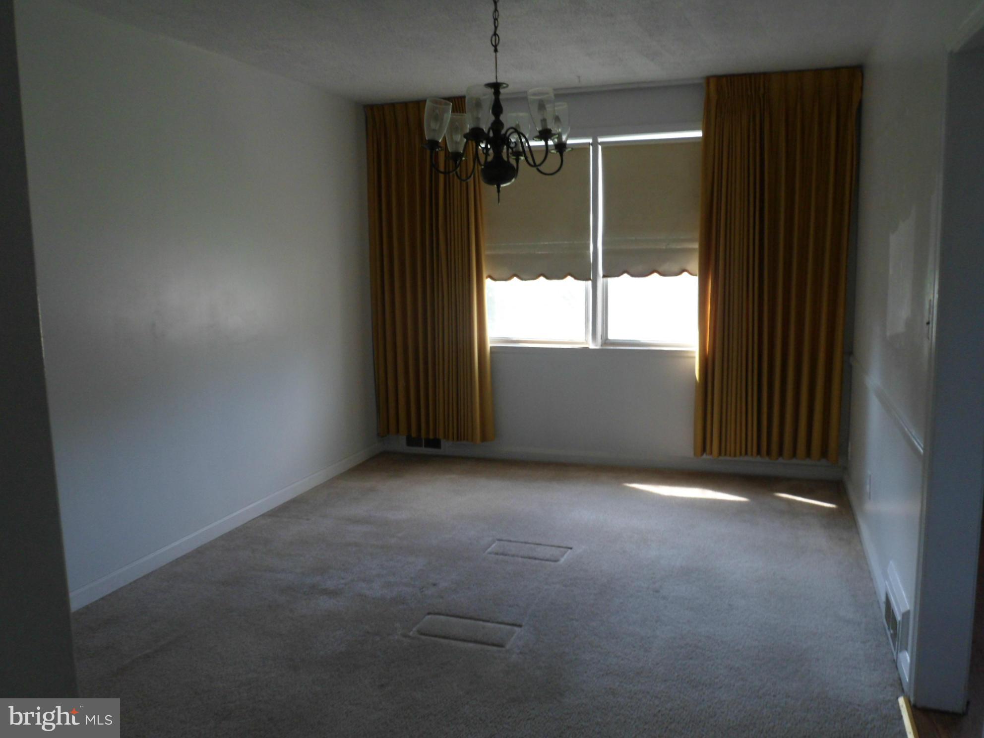 1333 Stonewood Road Baltimore, MD 21239 - Photo 9 of 30 a view of a room with a ceiling fan and window