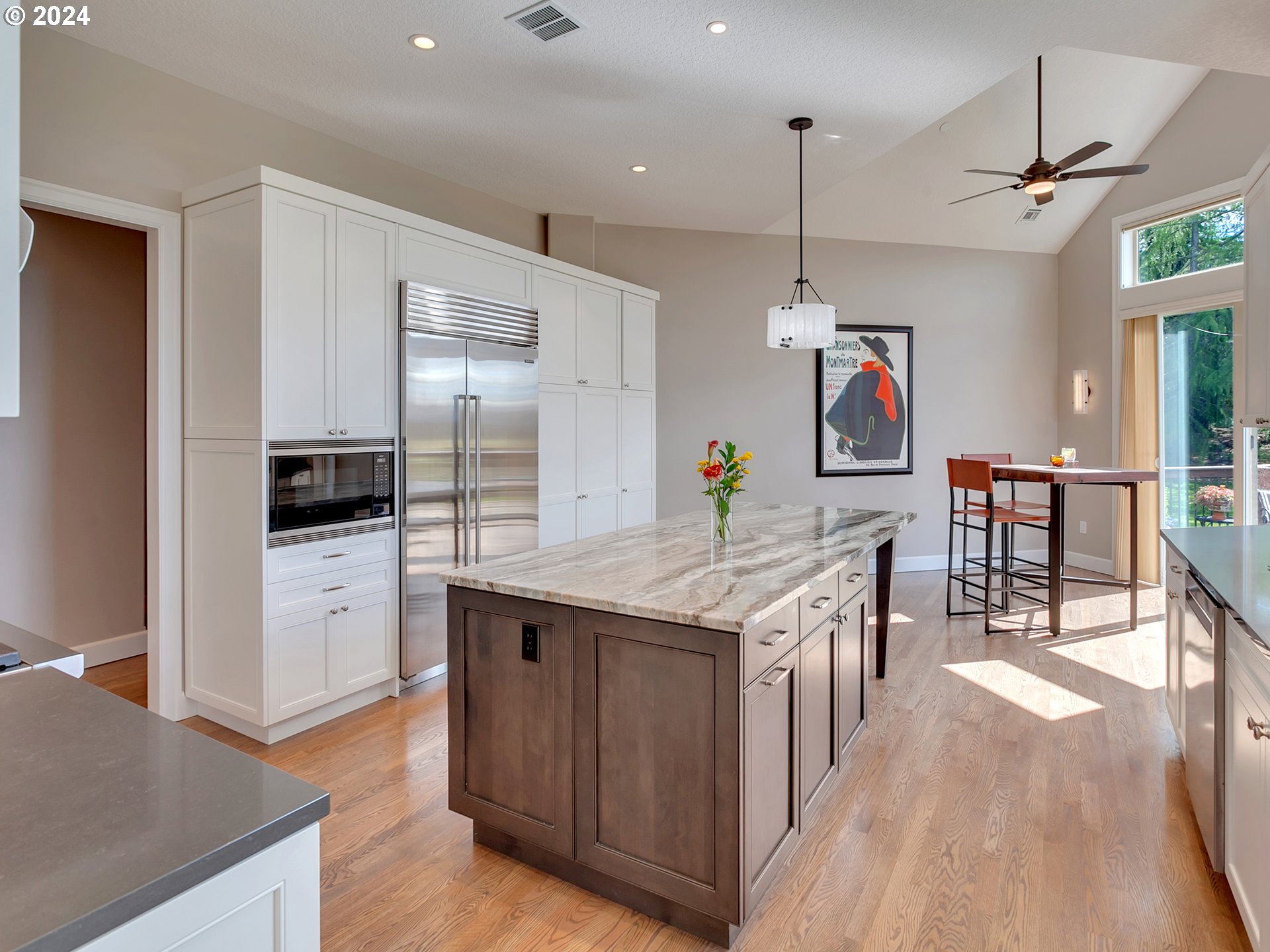 26317 Southwest Labrousse Road Sherwood, OR 97140 - Photo 11 of 38 a kitchen with kitchen island granite countertop a stove and a wooden floors