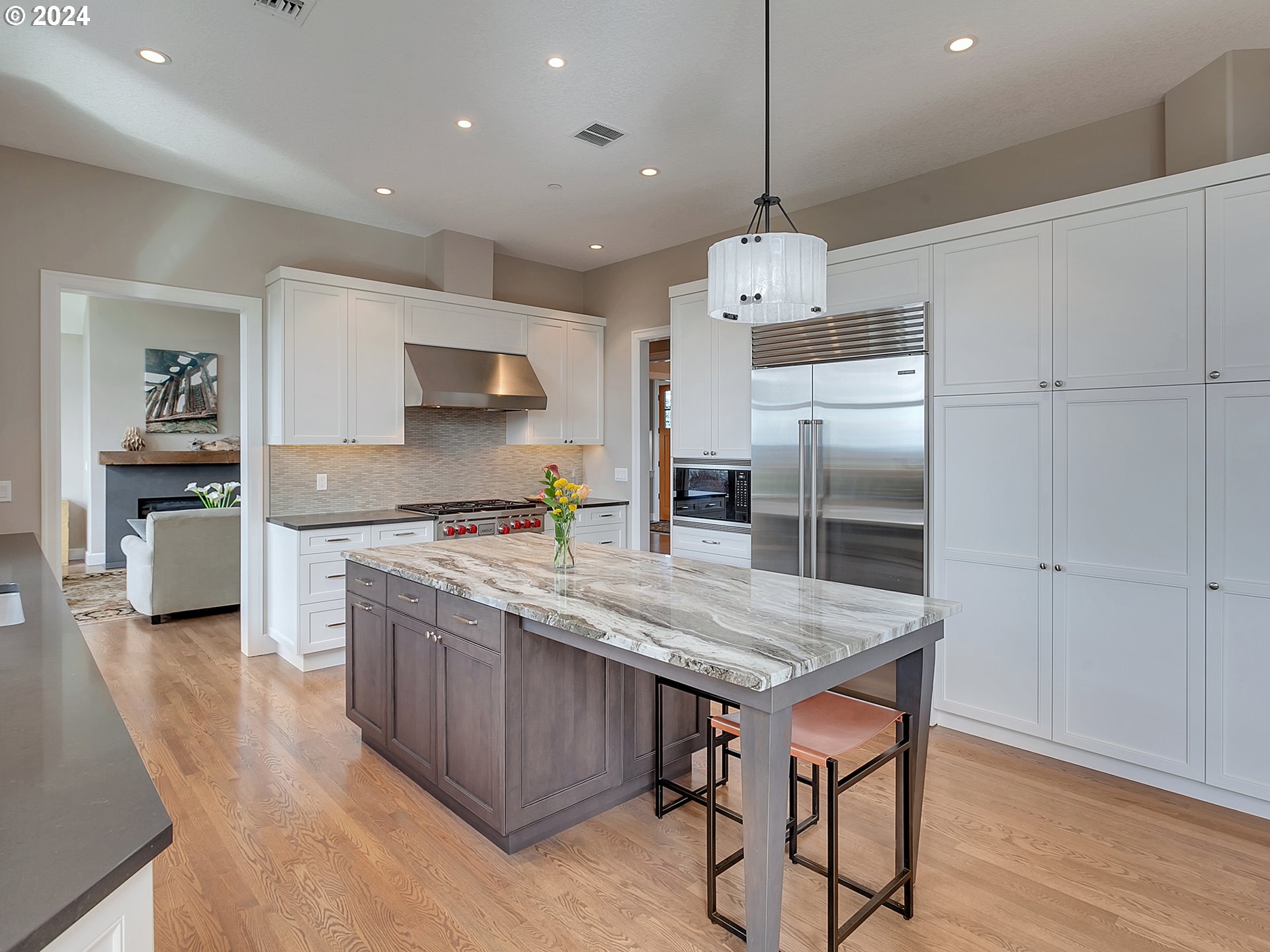 26317 Southwest Labrousse Road Sherwood, OR 97140 - Photo 12 of 38 a kitchen with a stove a refrigerator and a wooden floor