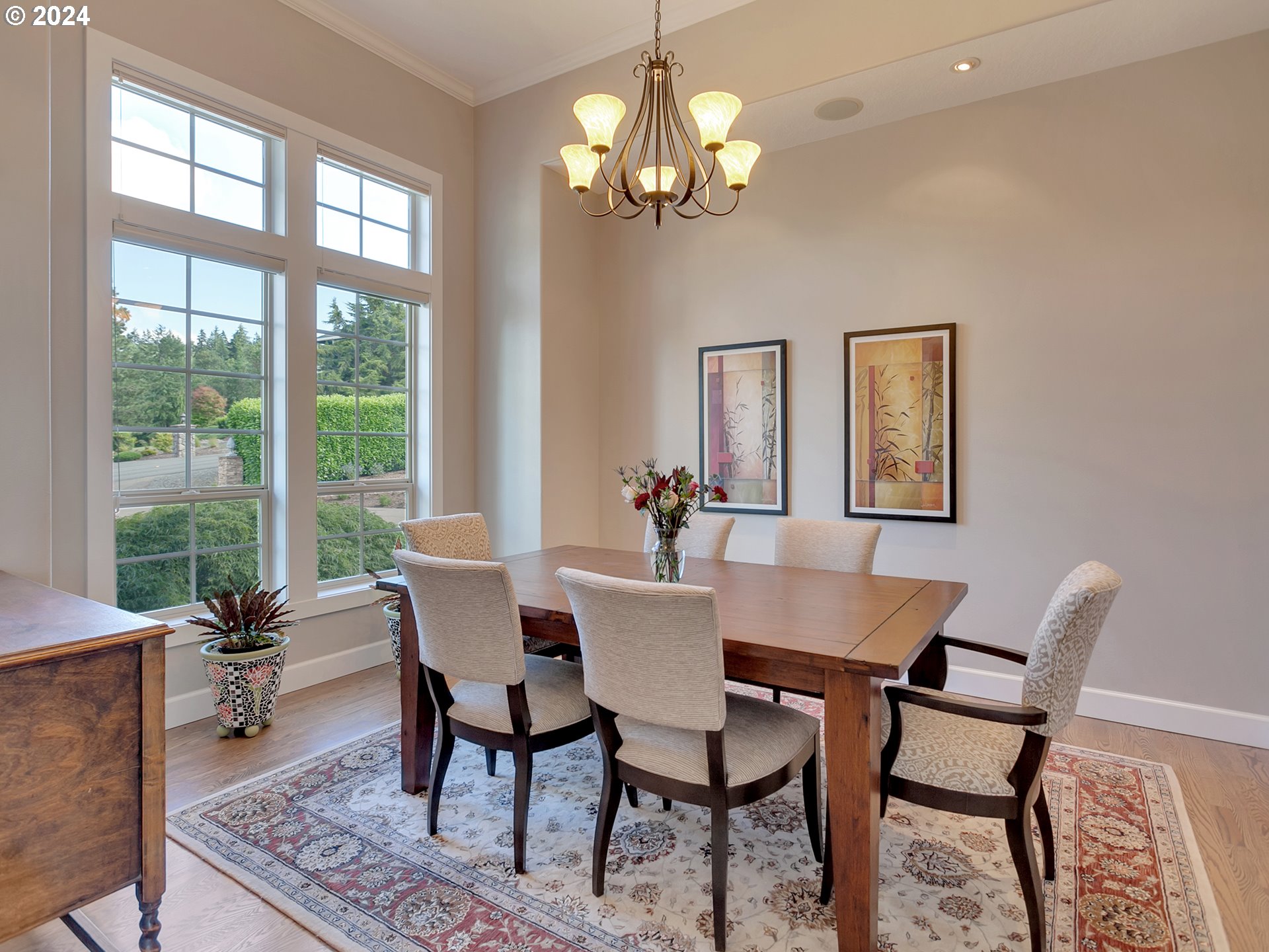 26317 Southwest Labrousse Road Sherwood, OR 97140 - Photo 9 of 38 a dining room with furniture a rug and a chandelier