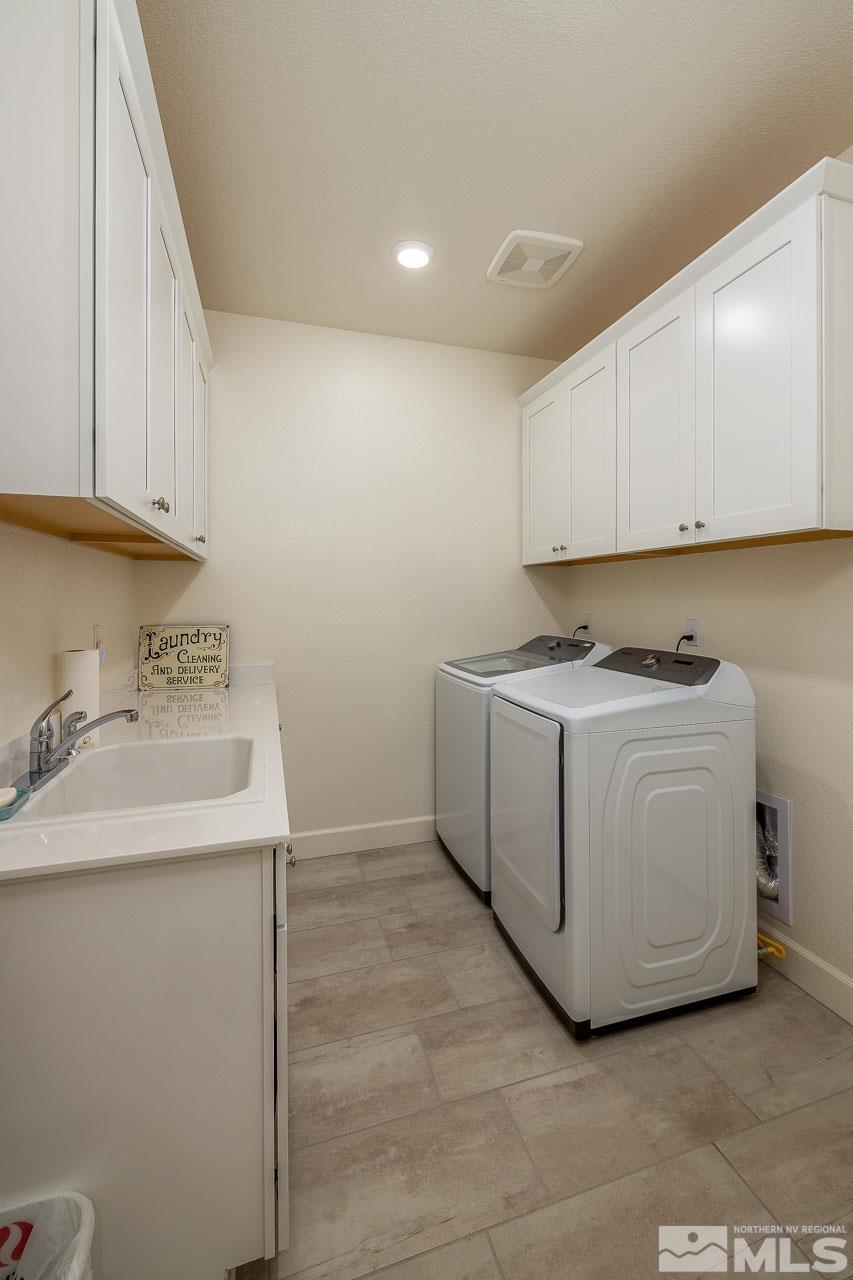 4501 High Pointe Drive Reno, NV 89521 - Photo 13 of 26 a utility room with cabinets washer and dryer