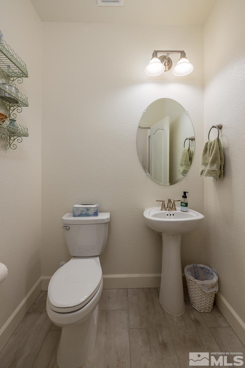 4501 High Pointe Drive Reno, NV 89521 - Photo 14 of 26 a bathroom with a toilet sink and mirror