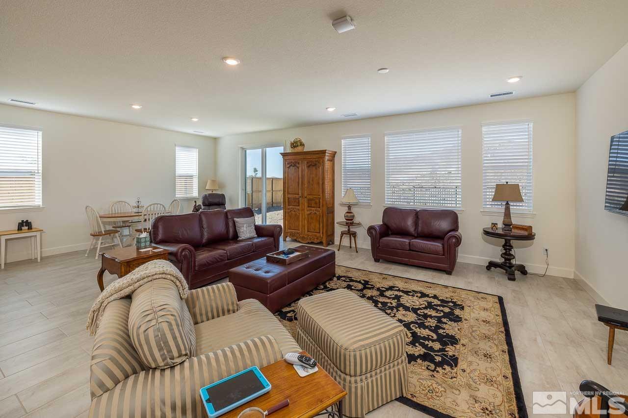 4501 High Pointe Drive Reno, NV 89521 - Photo 22 of 26 a living room with furniture ceiling fan and a rug